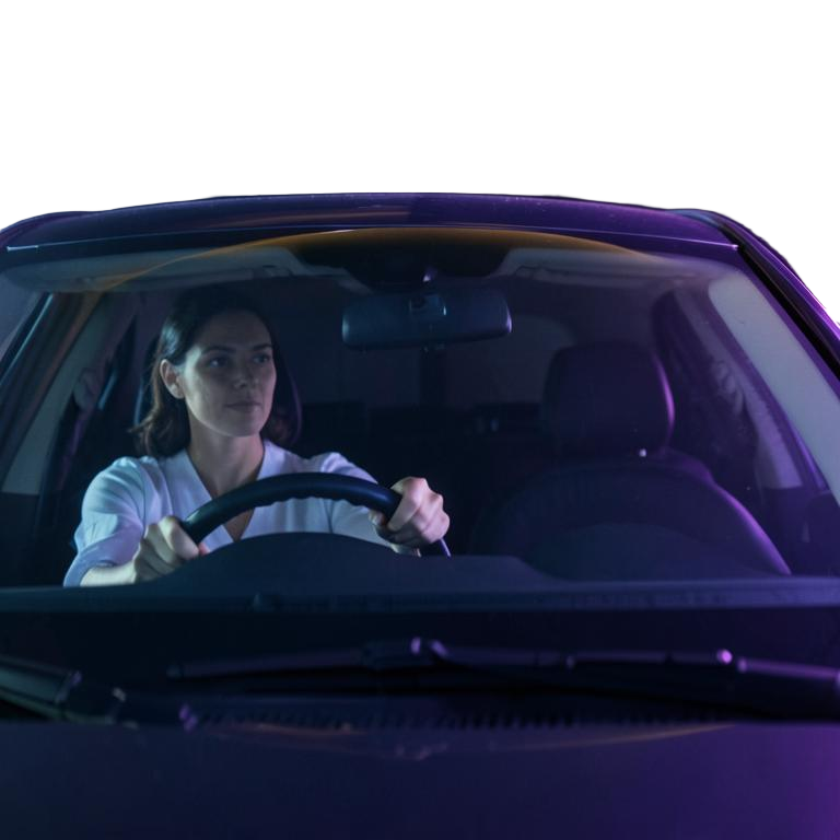 A focused driver at the wheel, representing motor vehicle safety and personal injury prevention